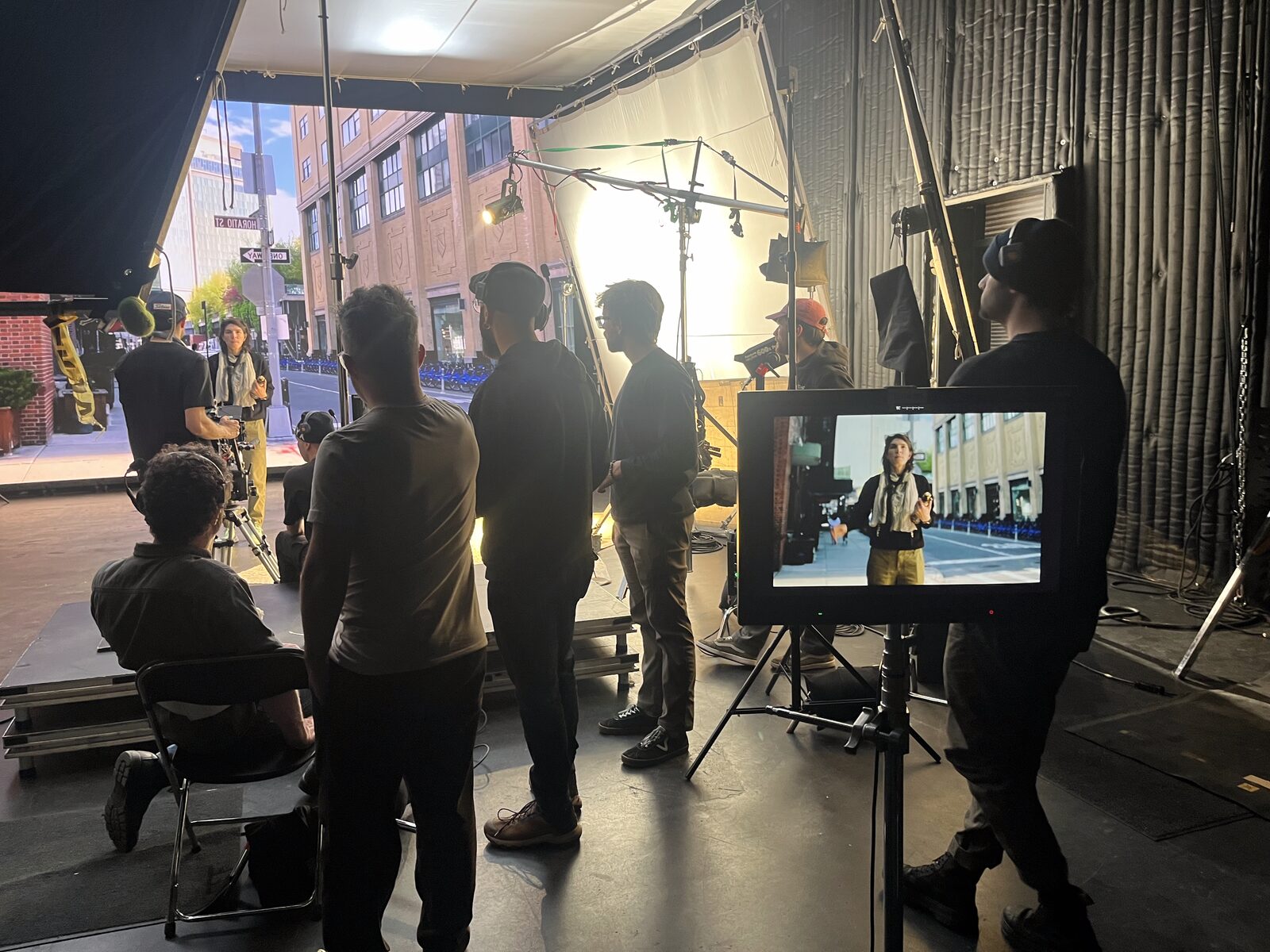 Agency and crew gathered at the monitor on set